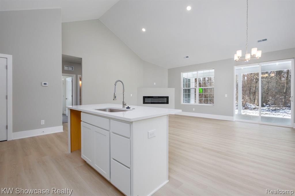 Unfurnished Great Room with Plenty of Natural Light, Fireplace and Vaulted Ceiling, Property Under Construction.