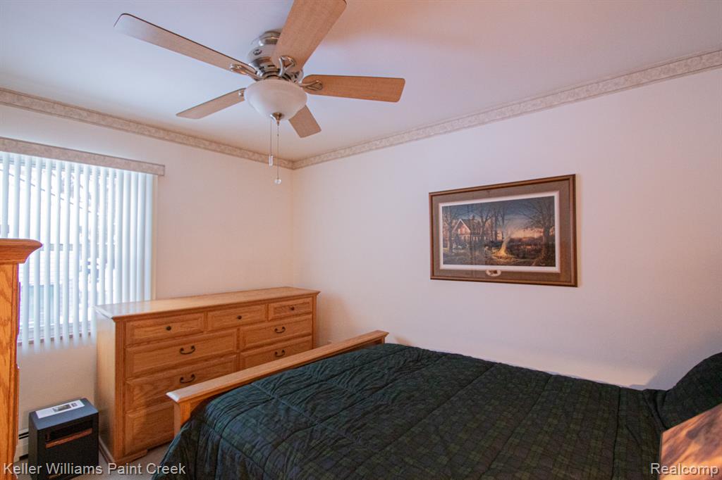 Bedroom with a ceiling fan and carpet floors