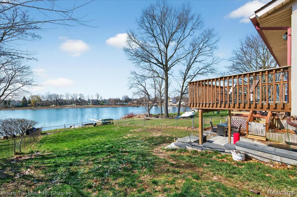 View of yard featuring a deck with water view