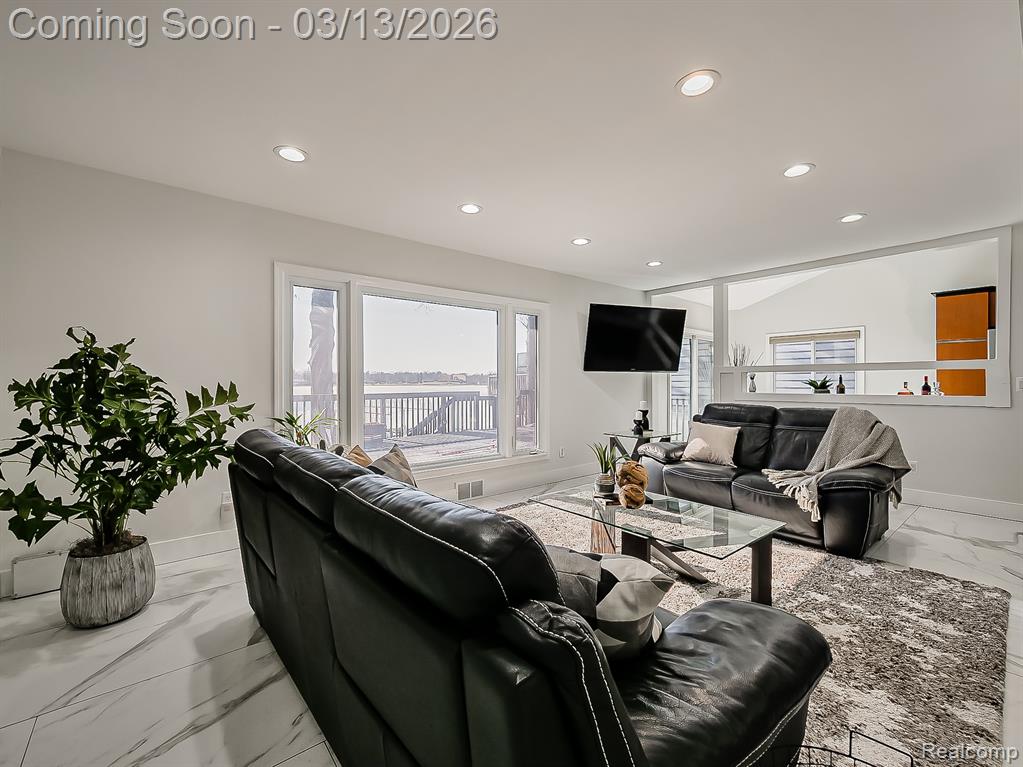 Kitchen with stainless steel appliances, light marble finish floors, backsplash, recessed lighting, and light stone countertops
