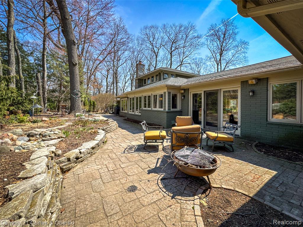 View of patio / terrace featuring a fire pit and a sunroom