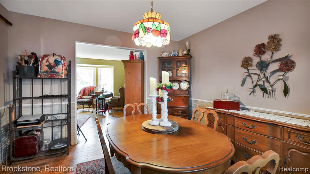 Dining area with wood finished floors and a chandelier