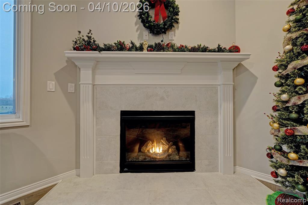 Detailed view of a tiled fireplace and baseboards