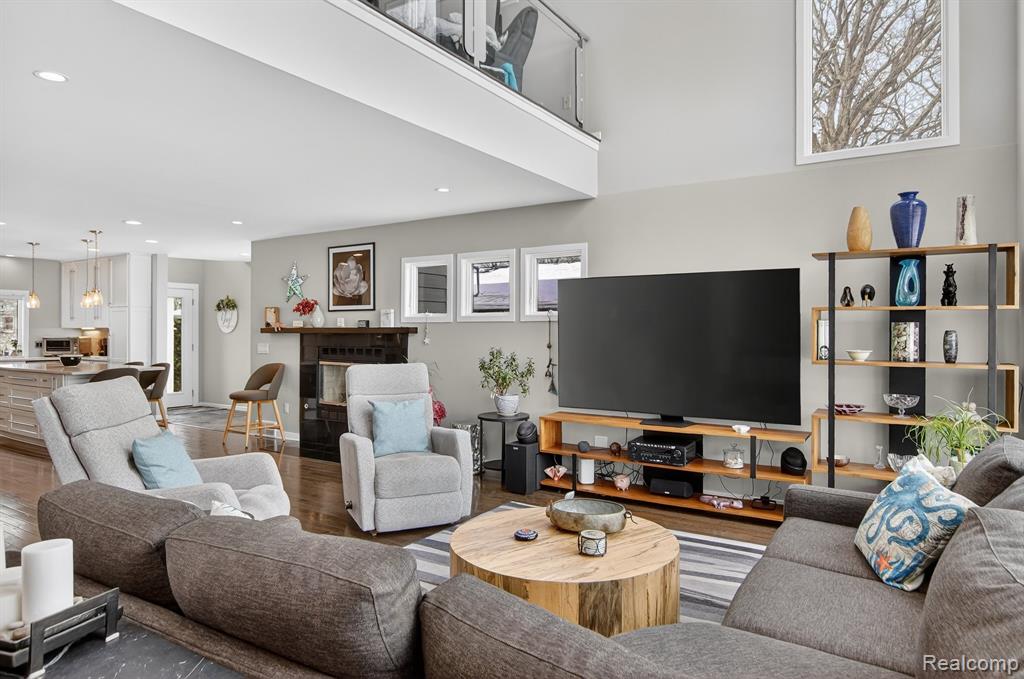 Living area featuring wood finished floors and a high ceiling