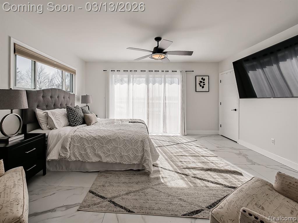 Walk in closet featuring light marble finish floors