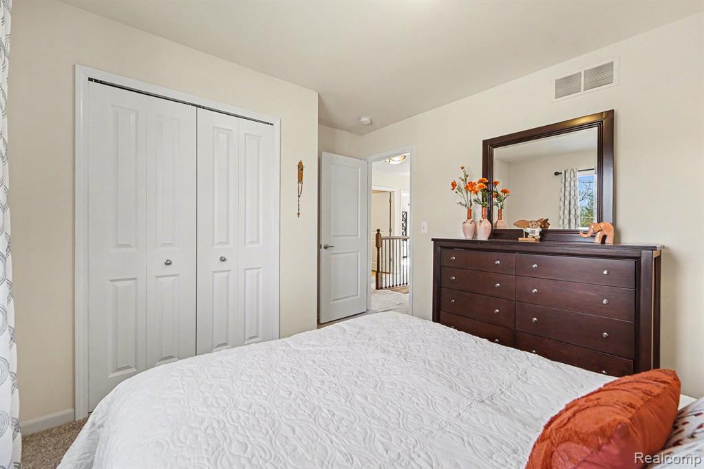 Bedroom featuring a closet and light carpet