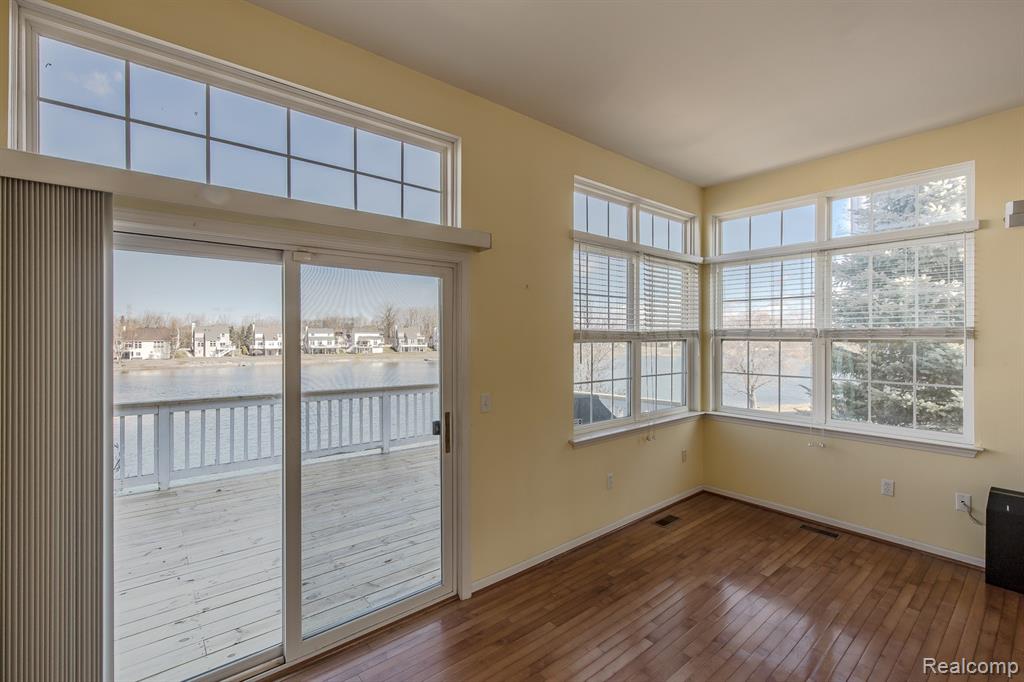 Doorwall leading to deck and lake views.