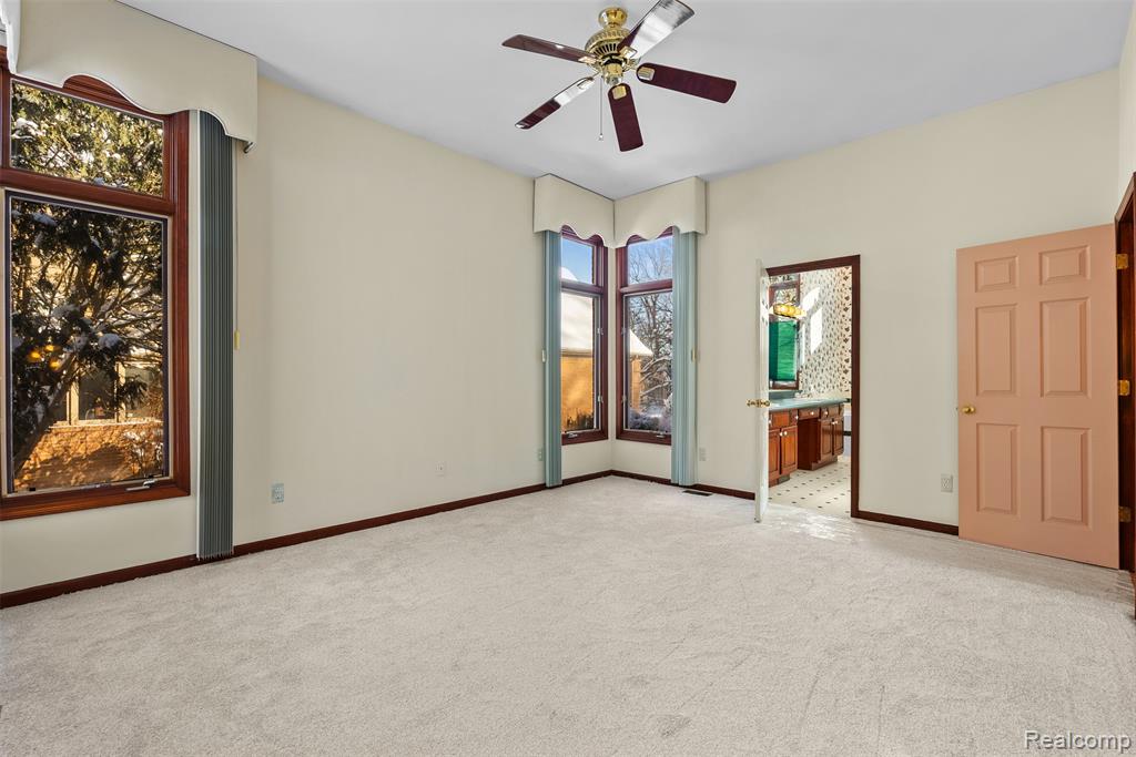 Unfurnished bedroom featuring carpet and ceiling fan