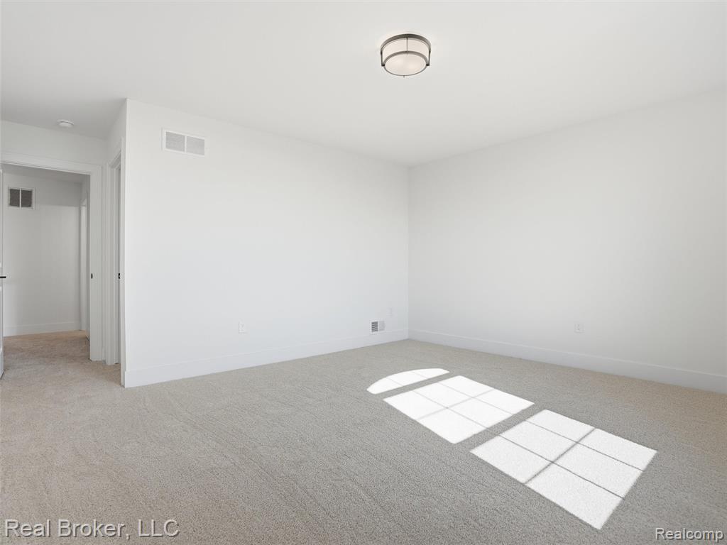 Spare room with light colored carpet