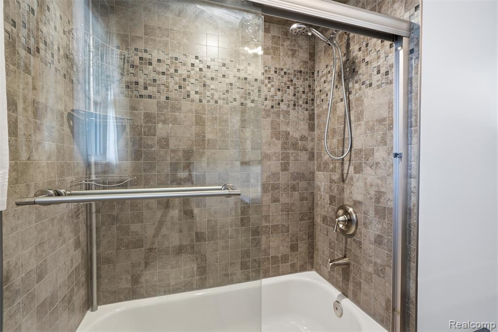 Bathroom featuring enclosed tub / shower combo
