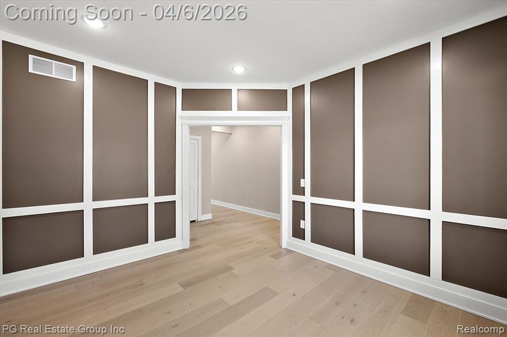 Walk in closet with light wood-style floors