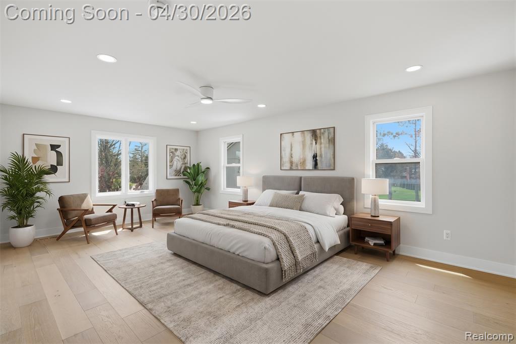 Bedroom featuring light wood finished floors, a ceiling fan, and recessed lighting
