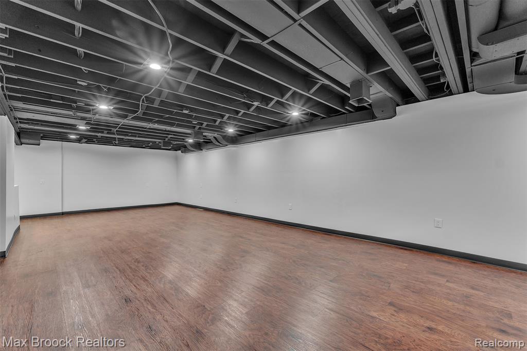 Finished basement with wood finished floors and baseboards