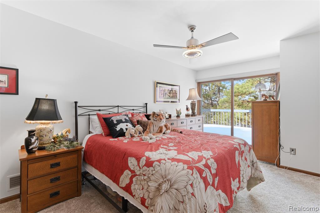 Bedroom with light carpet, access to outside, and ceiling fan