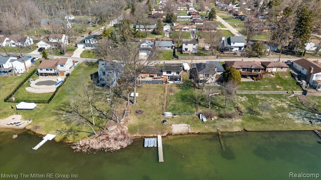 Aerial view of property's location with nearby suburban area and a large body of water