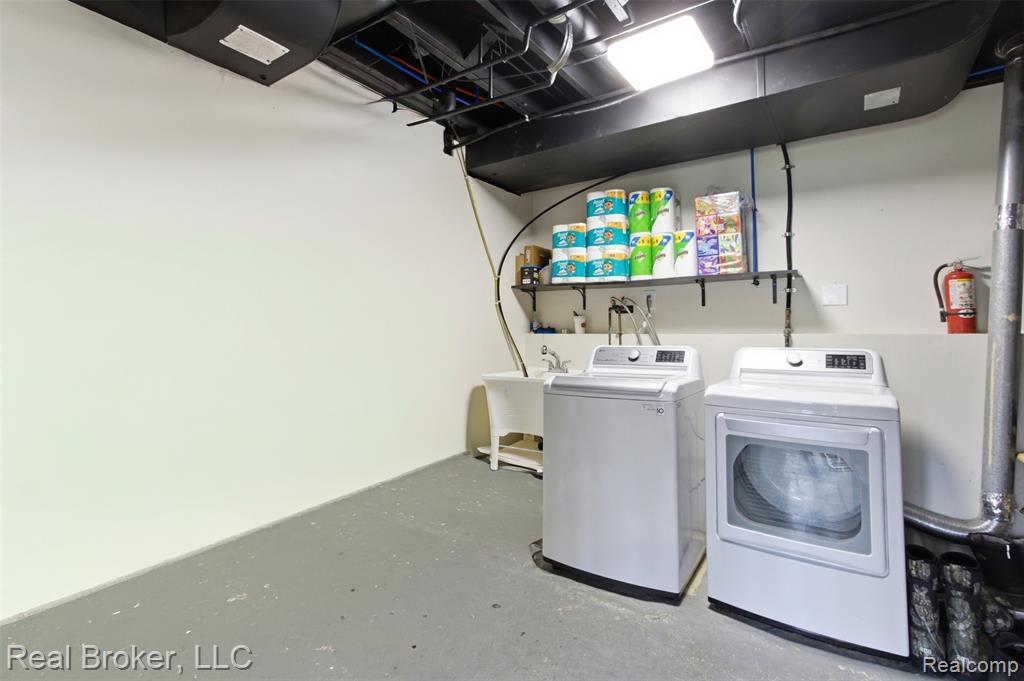 Laundry area featuring concrete flooring and separate washer and dryer