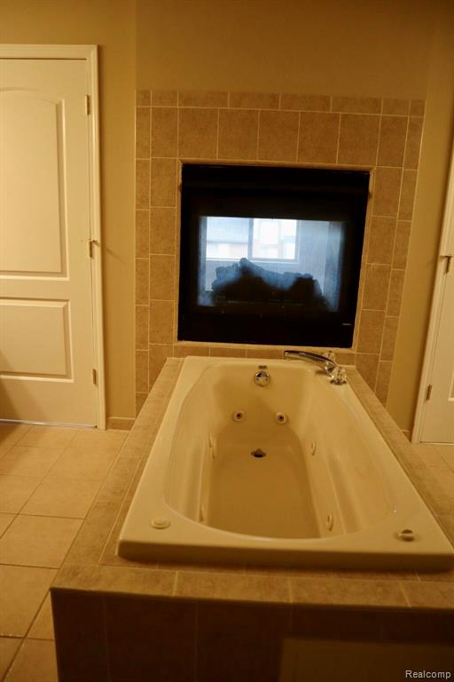 Unfurnished bedroom featuring carpet, a closet, and ensuite bath