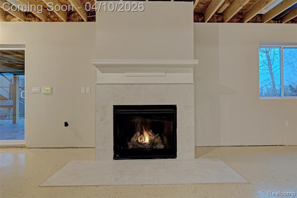 Detailed view of a fireplace with flush hearth and speckled floor