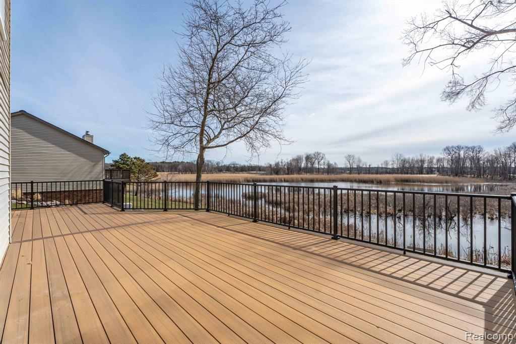 Wooden deck featuring a water view