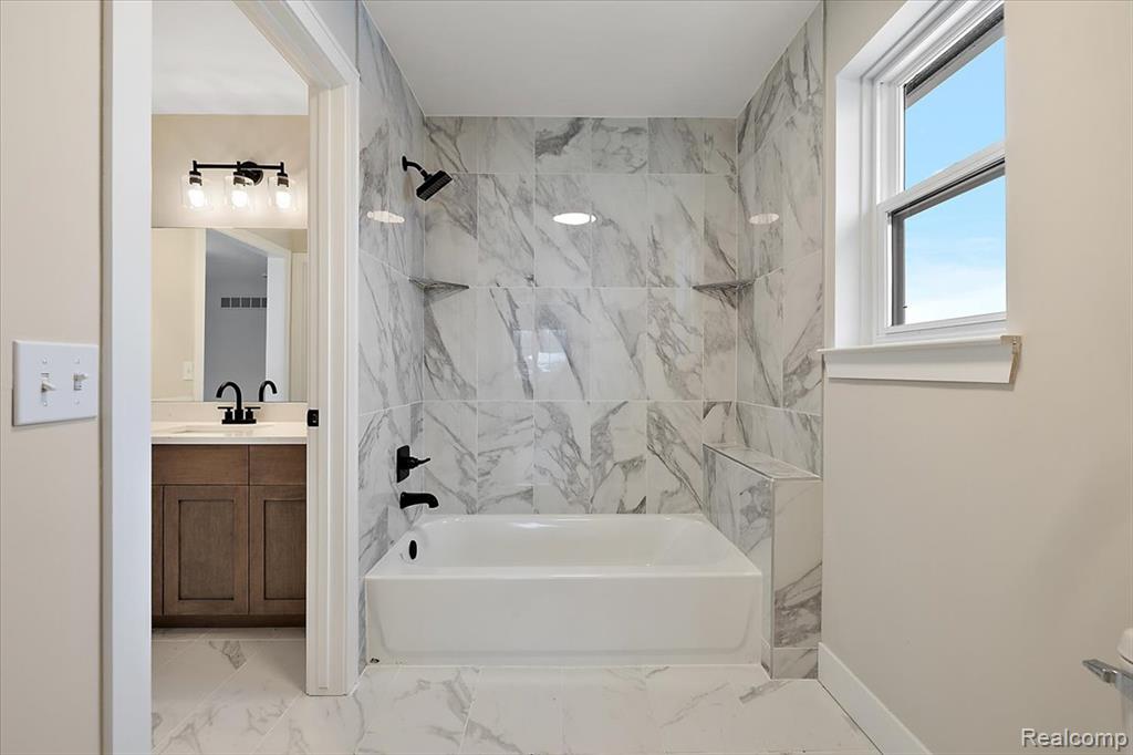 Full bathroom featuring vanity, shower / washtub combination