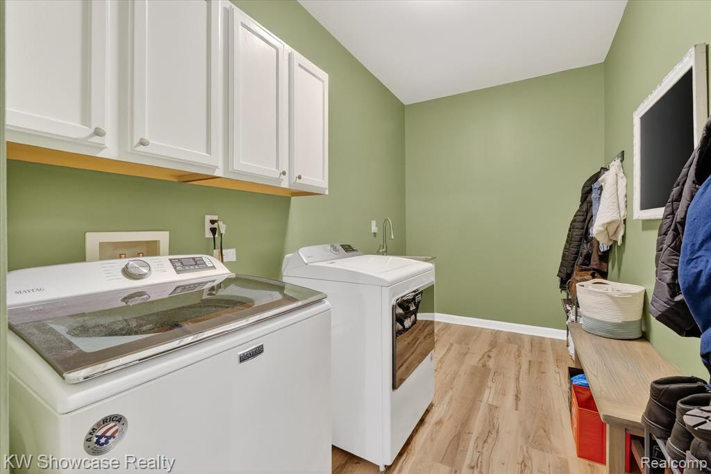 Bedroom with ceiling fan, dark wood-style floors, and connected bathroom