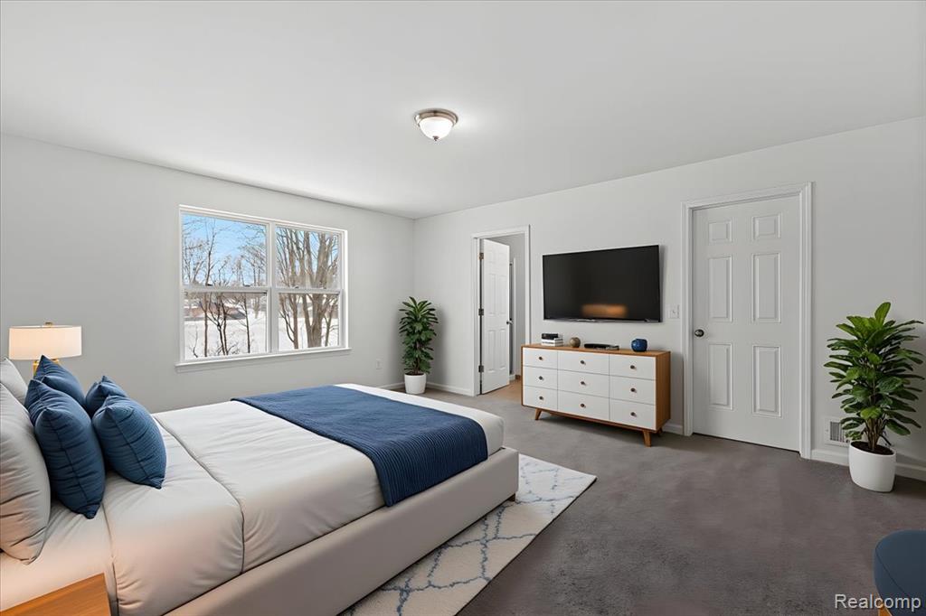 Kitchen with a kitchen island, hanging light fixtures, stainless steel refrigerator, light wood finished floors, and open floor plan