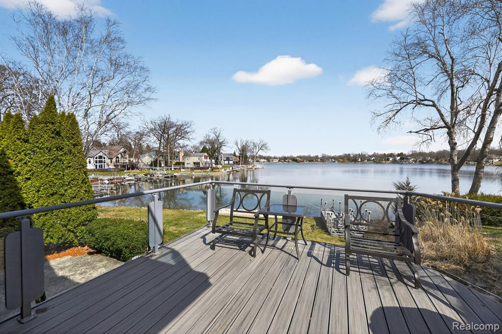 Deck featuring a water view and a residential view