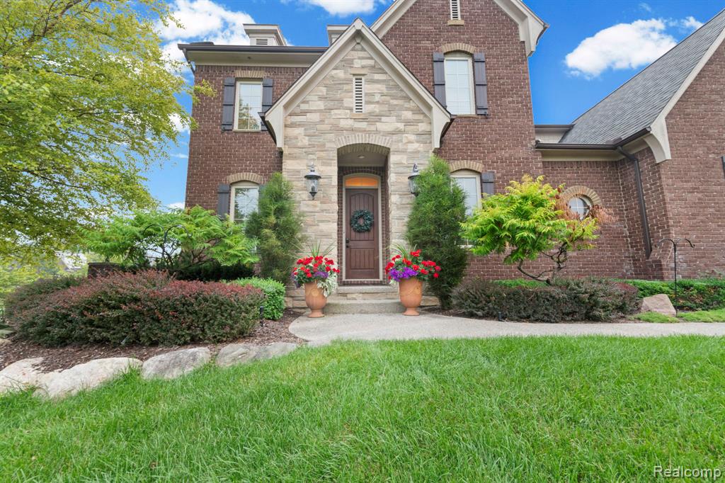 Brick and stone facade featuring an arched entryway