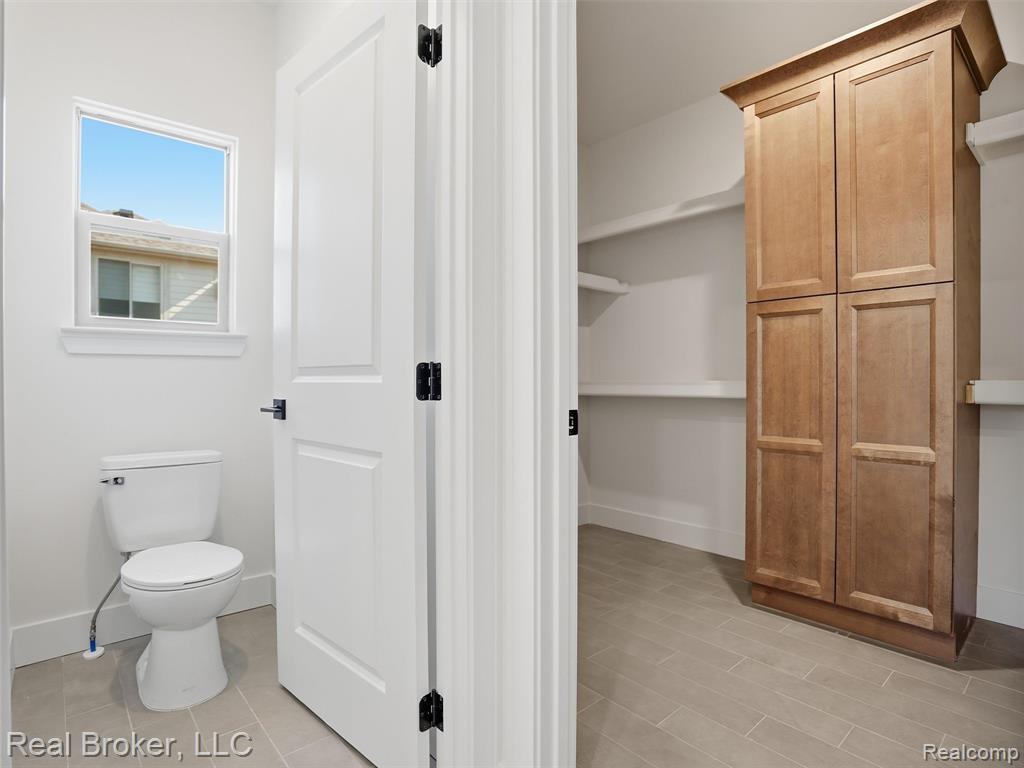 Bathroom featuring toilet and baseboards