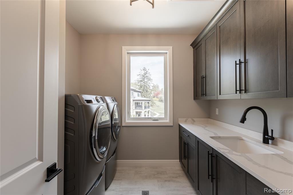 Laundry area with independent washer and dryer and cabinet space