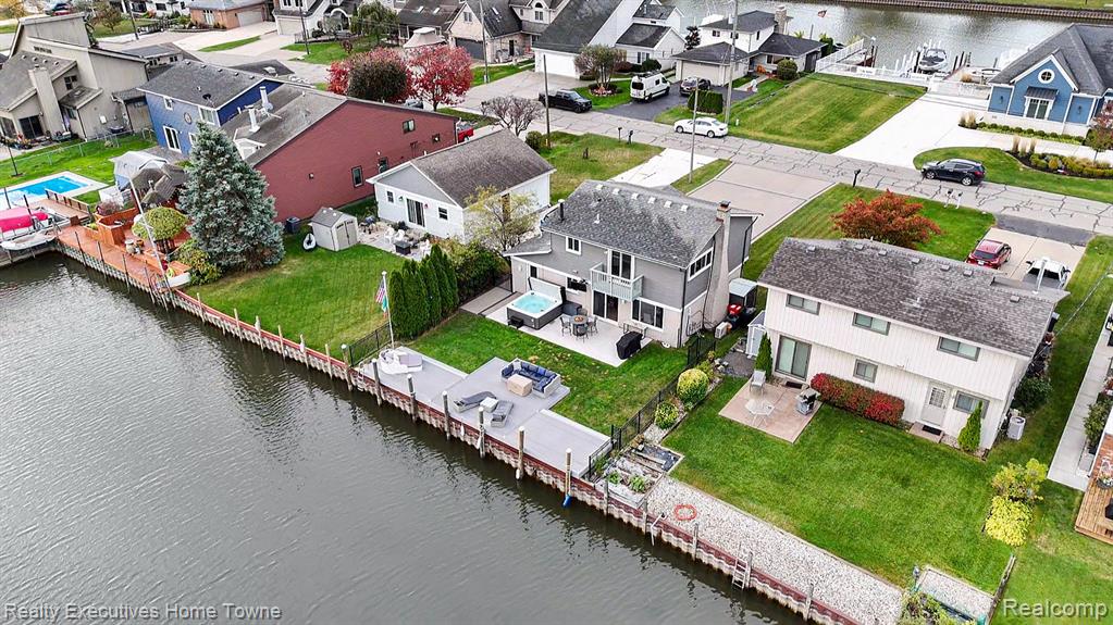 Aerial perspective of suburban area featuring a nearby body of water