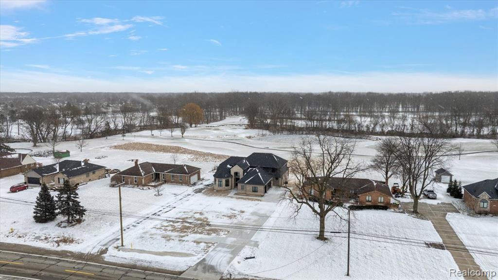 Snowy aerial view featuring a residential view