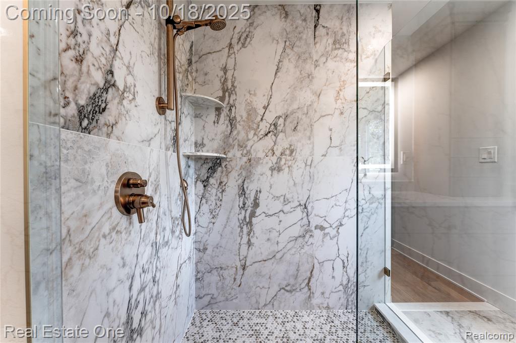 Bathroom featuring a marble finish shower