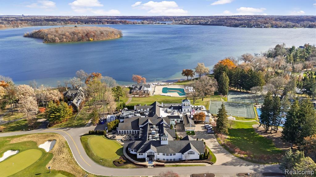 Aerial view of property and surrounding area with a nearby body of water