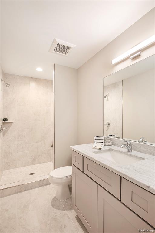 Full bathroom with vanity and tiled shower