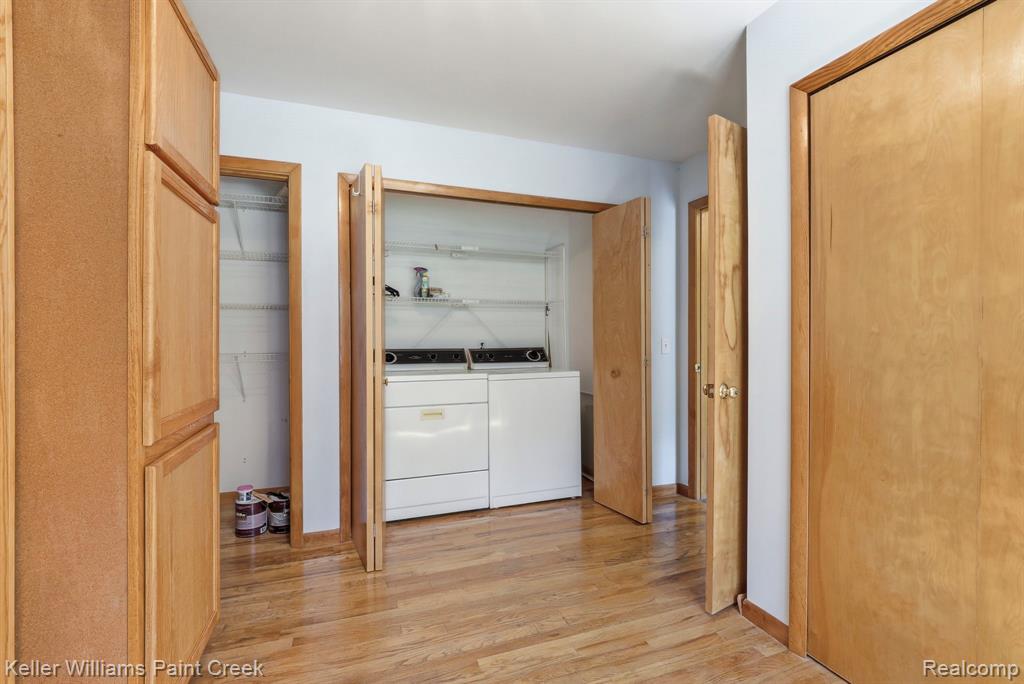 Hardwood-finish flooring throughout, integrated laundry appliances, bi-fold closet doors, and wood-finish cabinetry