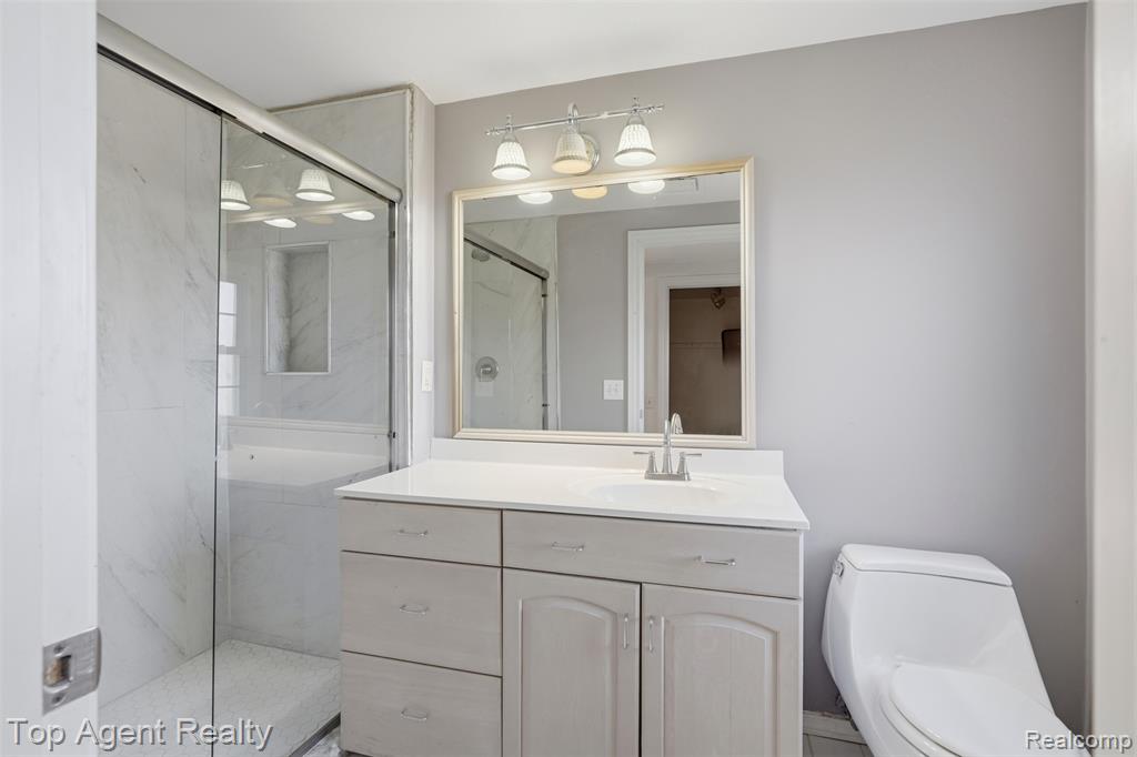 Bathroom featuring vanity and shower / bath combination with curtain