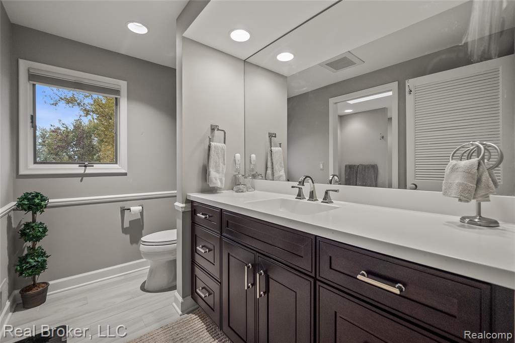 Bathroom featuring vanity, recessed lighting, and light wood-style floors