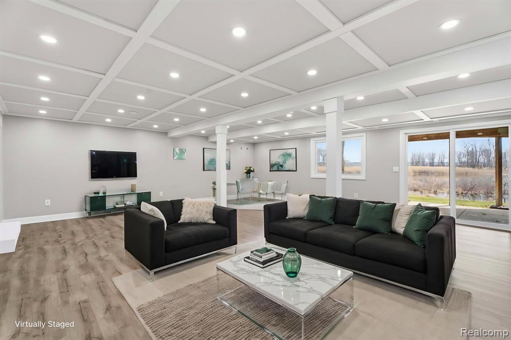 Living room featuring recessed lighting, light wood-style flooring, and coffered ceiling