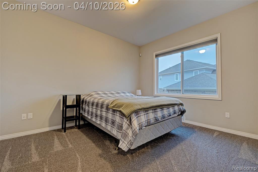 Carpeted bedroom featuring baseboards