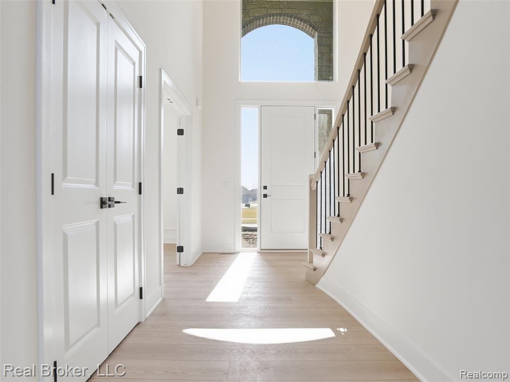 Entryway featuring light wood-style flooring and a high ceiling