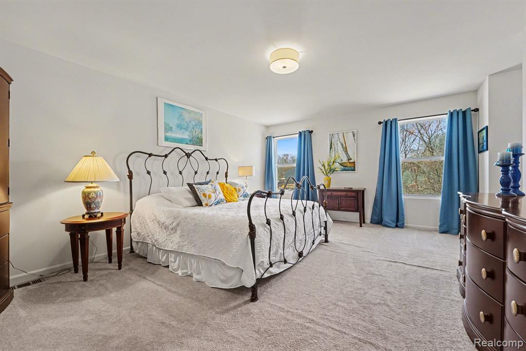 Bedroom with light colored carpet