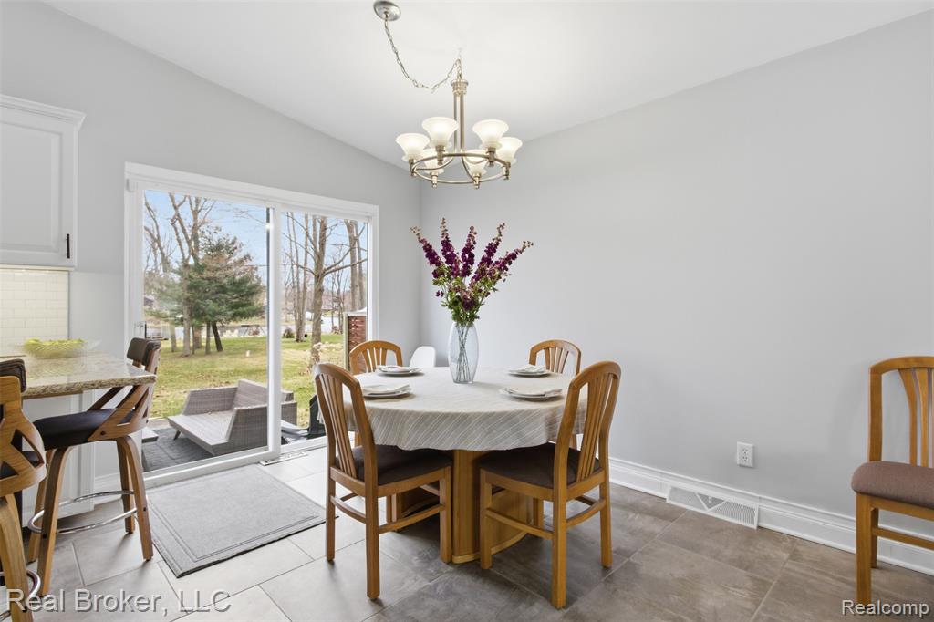 Dining room with hanging lights and vaulted ceiling