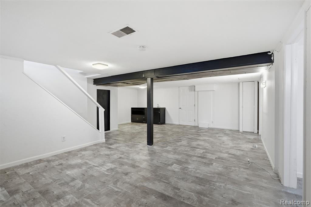 Finished below grade area featuring light wood-style floors and baseboards