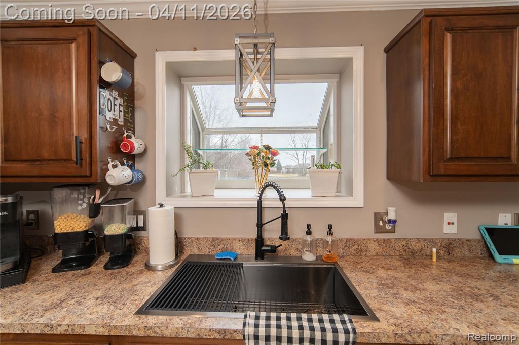 Kitchen with a sink and decorative light fixtures