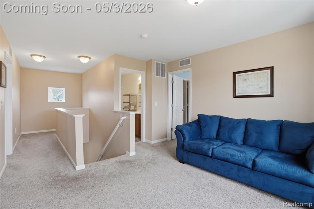 Carpeted living room with baseboards