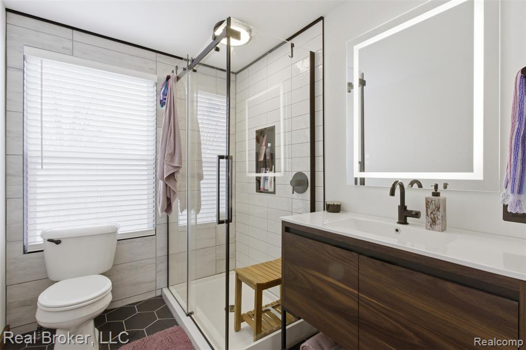 Bathroom featuring vanity, a stall shower, and tile patterned floors
