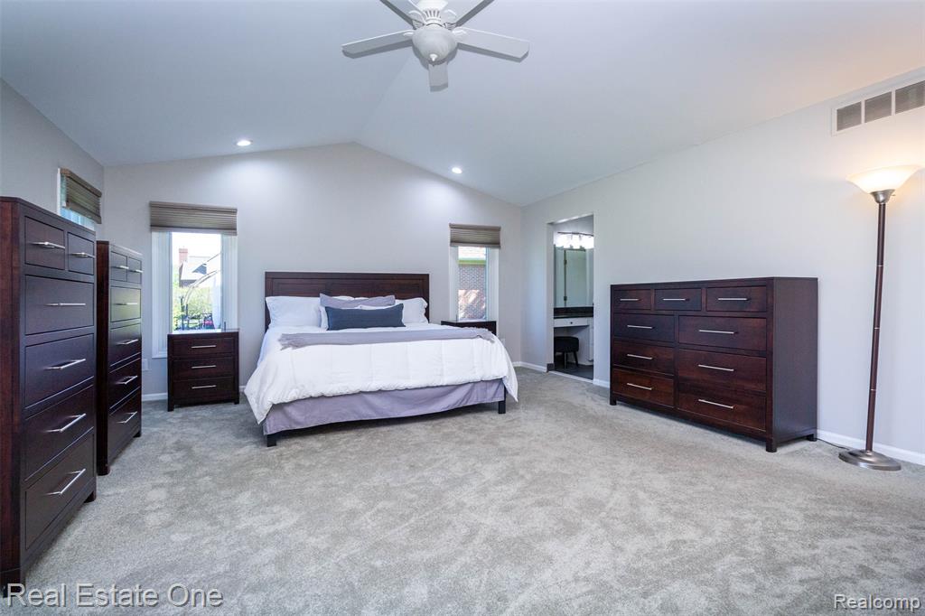 Primary Bedroom with multiple windows, cathedral ceiling