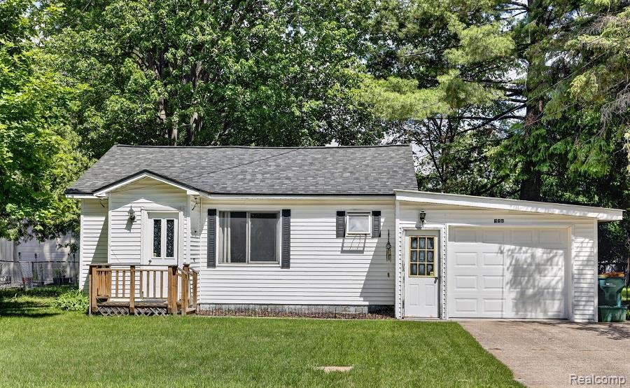 White vinyl siding exterior with a single-car garage
