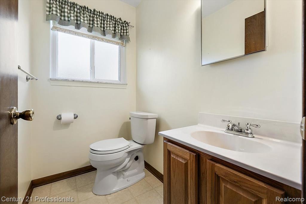 Half bath featuring vanity and toilet